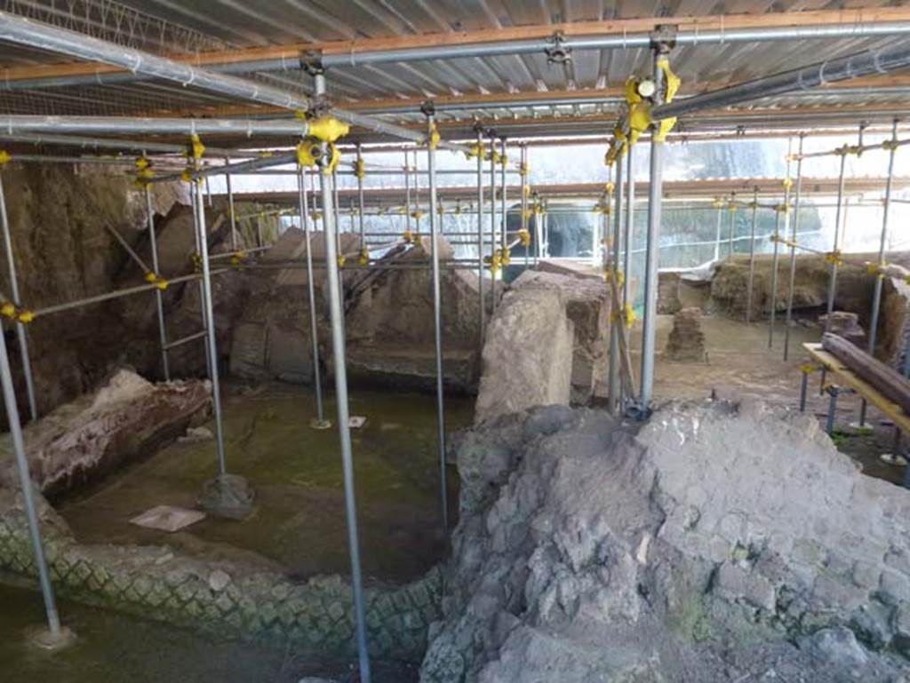 House of Dionysiac Reliefs, Herculaneum, seaside pavilion, June 2012. Room (a) and collapsed room (e) with room (b) to the right.
Photo courtesy of Michael Binns.